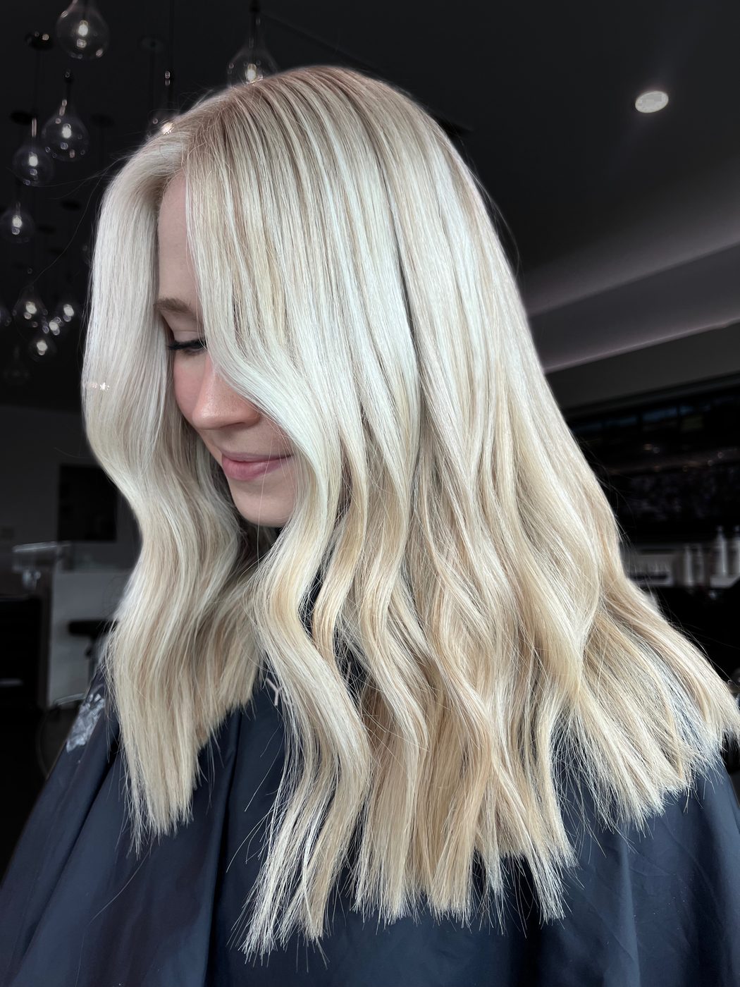 Bright lived-in blonde with soft waves, created in Polina's Findon studio