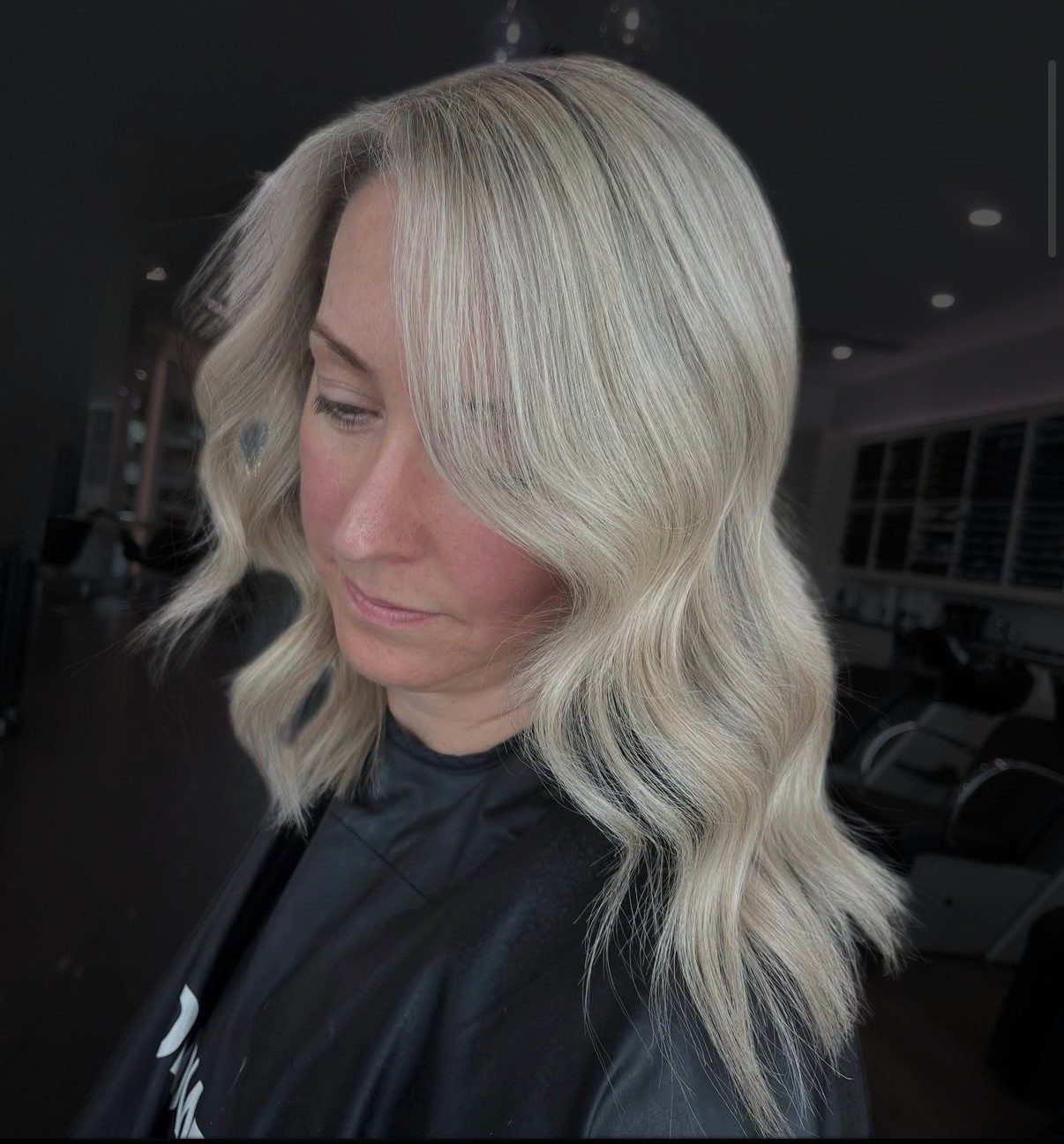 Icy blonde balayage styled in soft waves